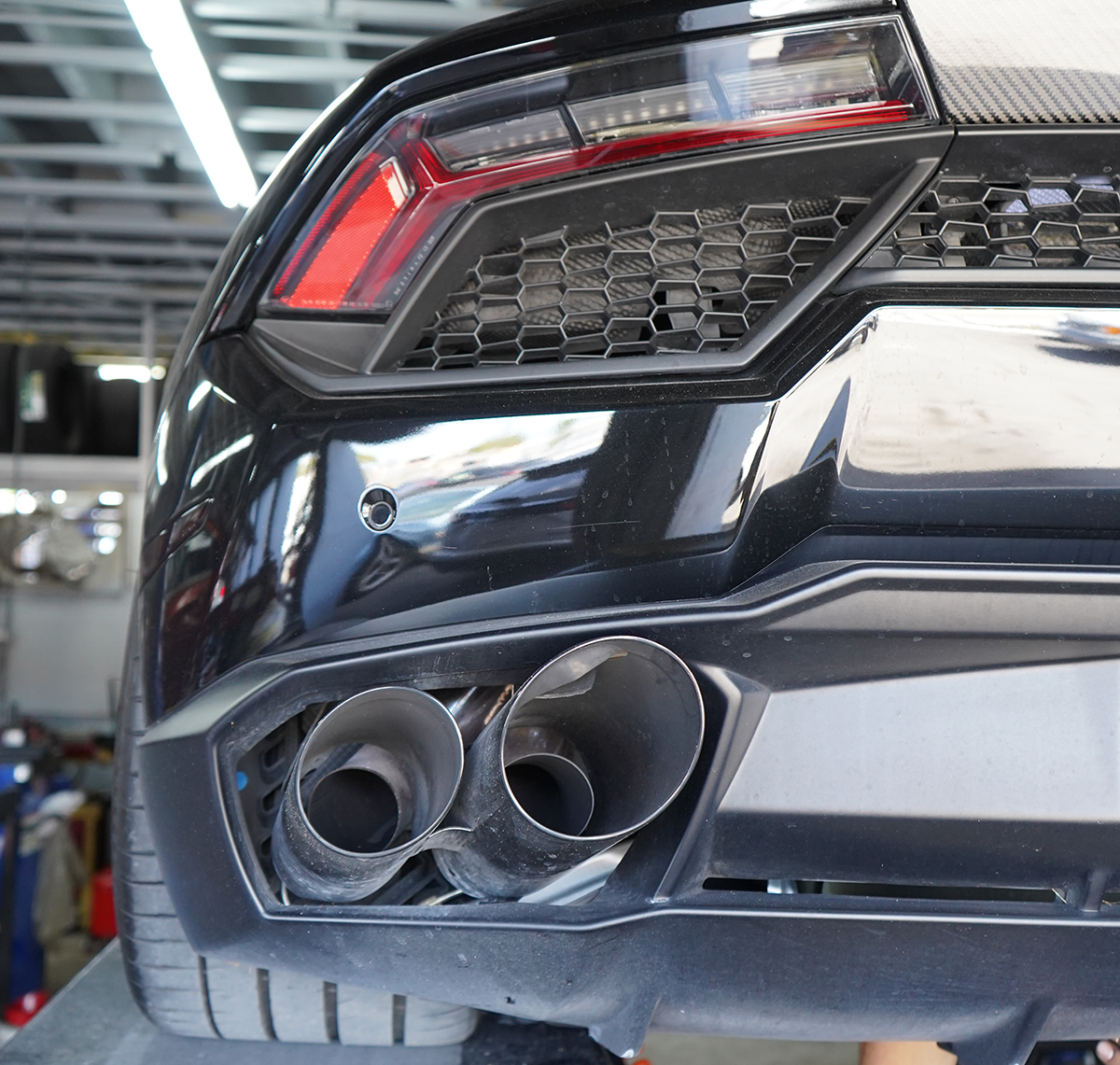 Exotic vehicle inside a clean automotive workshop