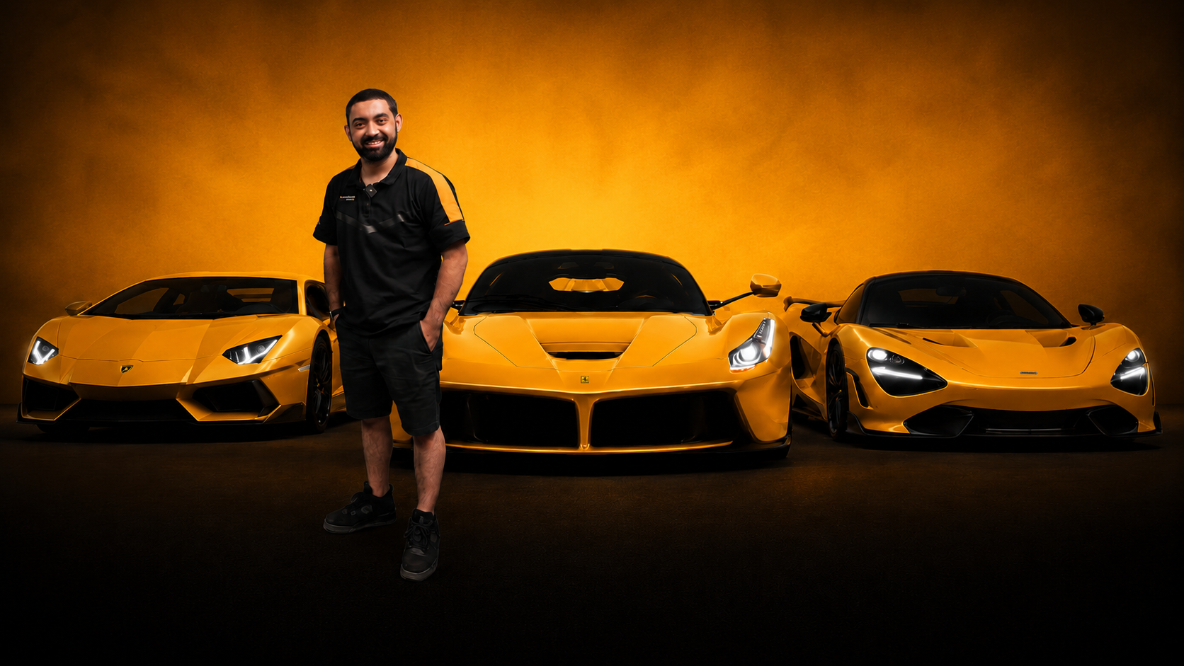 Jonathan of MBC NAPA Auto Care standing with a Lamborghini, Ferrari, and McLaren